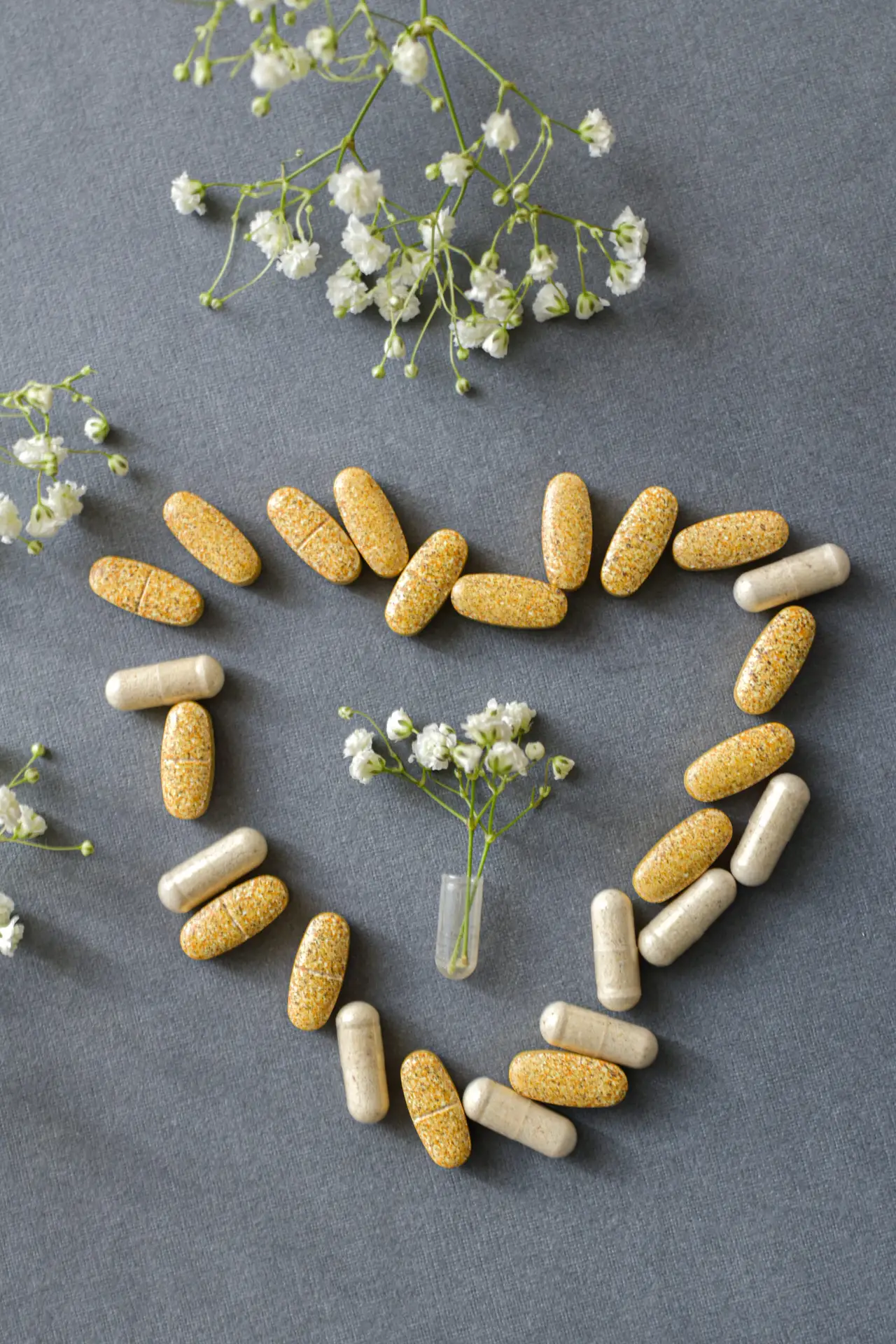 pills and flowers arranged in a heart shape 2026 03 16 06 06 34 utc scaled